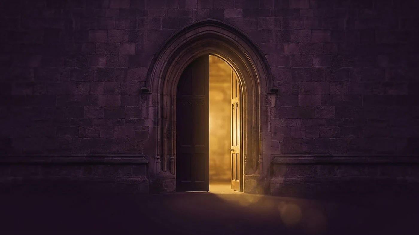An open arched doorway with warm light beyond